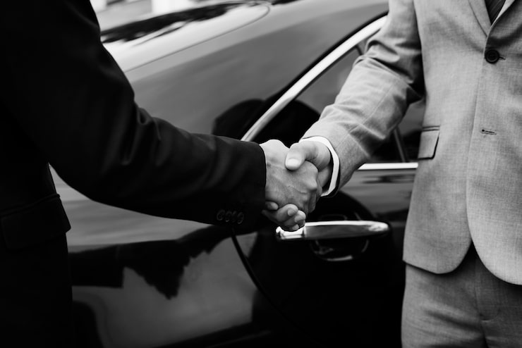 chauffeur shaking hand with client